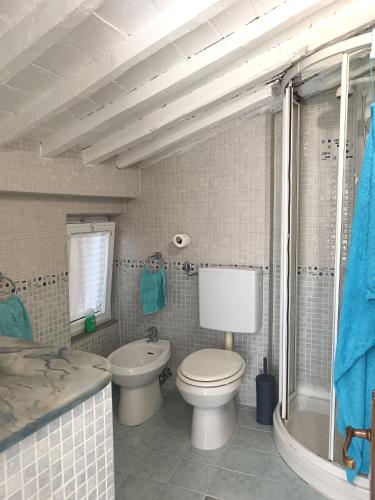 a bathroom with a toilet and a sink and a tub at Casa Martina in Arcola
