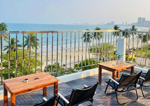 a balcony with two tables and chairs and the beach at Sontra Sea Hotel in Da Nang