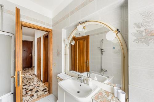 a bathroom with a sink and a mirror at Cozy Apartment near Venice with Balcony! in Campalto