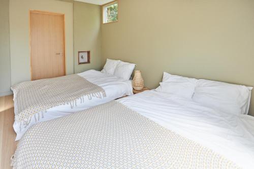 two beds sitting next to each other in a bedroom at HATa in Tokyo