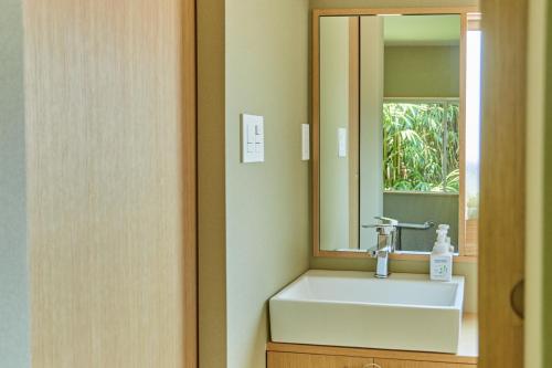 a bathroom with a sink and a mirror at HATa in Tokyo