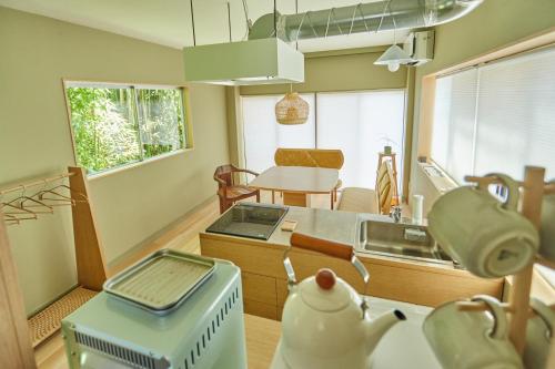 a kitchen with a stove and a sink in it at HATa in Tokyo