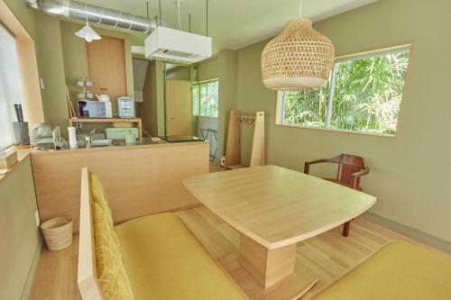 a dining room with a table and a kitchen at HATa in Tokyo
