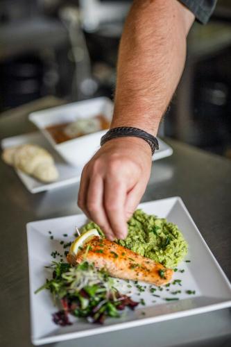 a person eating a plate of food on a table at Hotel Kačenka in Králíky