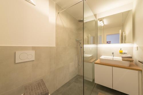 a bathroom with a sink and a shower at Haus Piger in Termeno