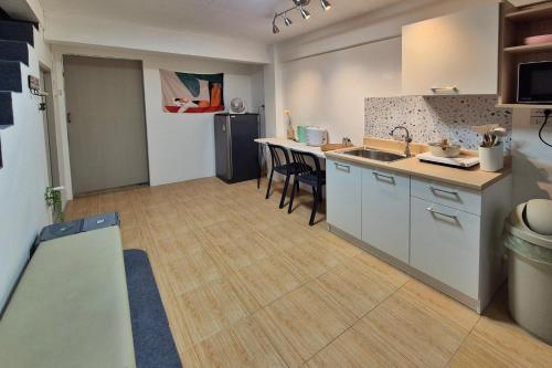 a kitchen with a sink and a counter at Townhouse at Yaek Lam Sali station for 6 pax in Ban Bang Toei (1)