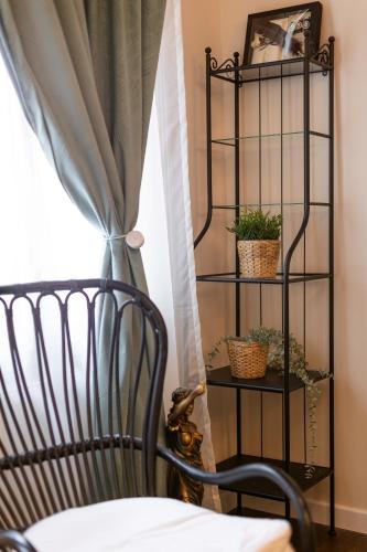 a room with a bed and a shelf with plants at Central Charm - 2BR Apartment in Timişoara