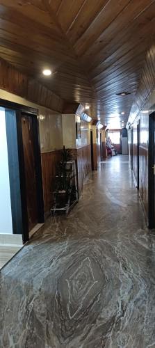 an empty room with a floor covered in marble at Hotel Assembly in Shillong