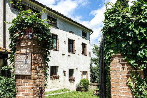 a white building with a sign in front of it at Torciano Hotel Wine & Winery, Tuscany in San Gimignano