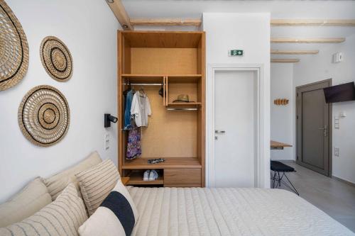 a bedroom with a bed and a closet at Perla's Luxury Apartments in Livadi