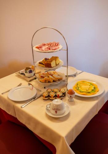 a table with plates of food on top of it at Torciano Hotel Wine & Winery, Tuscany in San Gimignano