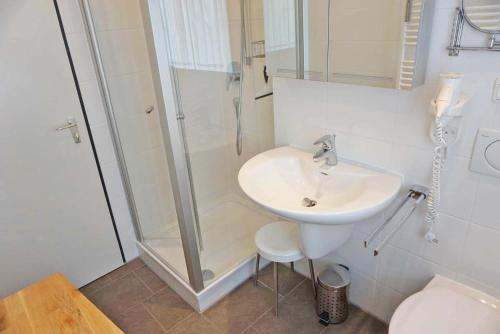a bathroom with a sink and a shower at Haus Obermaiselstein in Obermaiselstein
