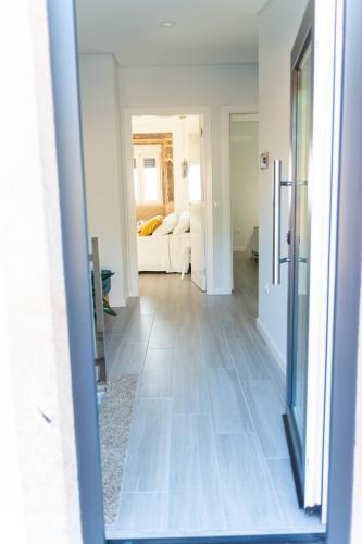 a view of a hallway with a living room at Guest House Taião in Valença