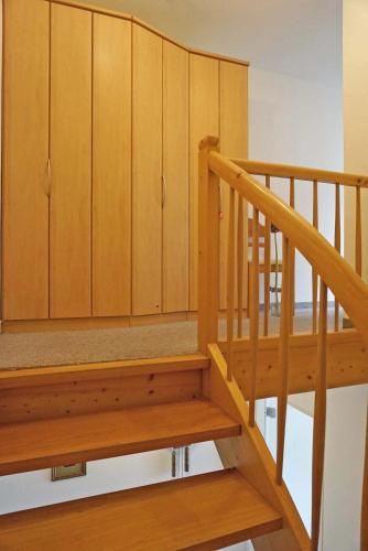 a staircase with wooden cabinets in a house at Haus Obermaiselstein in Obermaiselstein