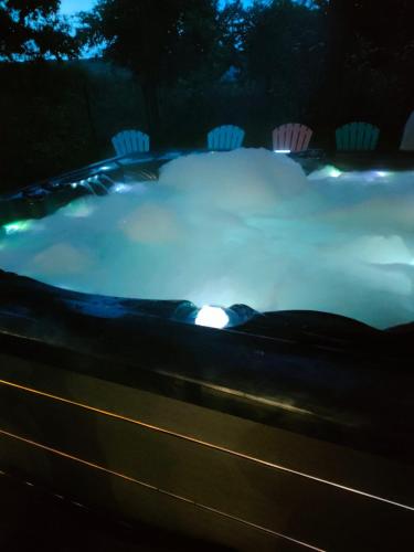 une piscine de neige la nuit avec des lumières dans l'établissement AU BON ACCUEIL A PORCARO AVEC ACCES au SPA EN ILLIMITE, à Porcaro