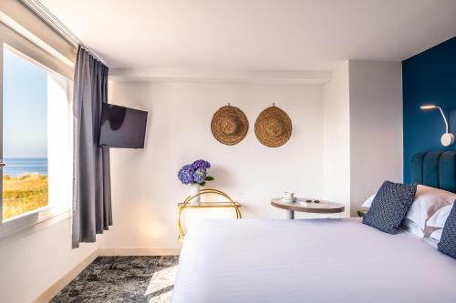 Postel nebo postele na pokoji v ubytování Hôtel Le Lichen De La Mer