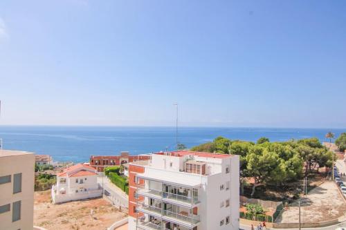 an aerial view of a building and the ocean at Apartamento con piscina - Plazamayor 251 in Calpe