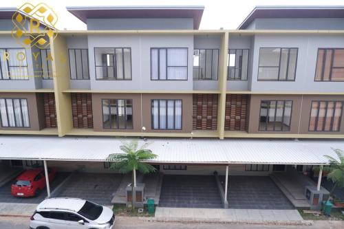 a white car parked in front of a building at Royal Suites Home Villa 3BR with Private Pool - C9 in Batam Center