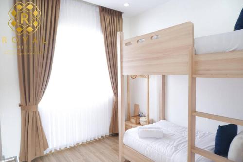 a bedroom with two bunk beds and a window at Royal Suites Home Villa 3BR with Private Pool - C9 in Batam Center