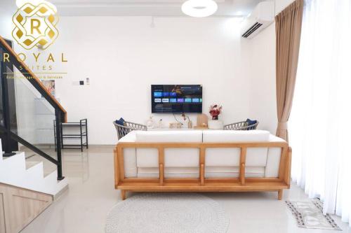 a room with a bed and a tv on a wall at Royal Suites Home Villa 3BR with Private Pool - C9 in Batam Center