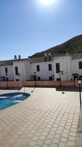 a courtyard with a pool and white buildings at Beautiful Duplex with a Patio in Alcalá de los Gazules