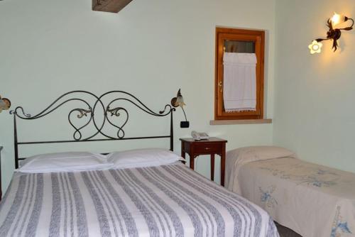 a bedroom with two beds and a mirror at Agriturismo Bortolino in Volta Mantovana