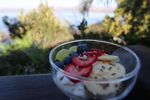a plastic cup filled with fruit on a table at Bali at Scenic Haven Lodge in Hartbeespoort in Hartbeespoort