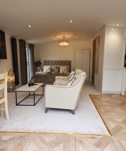 a living room with a couch and a bed at 1-Bed Studio with Parking Ideal for Couples in Newcastle upon Tyne