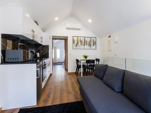 a living room with a couch and a table at Live in Aveiro Rossio in Aveiro