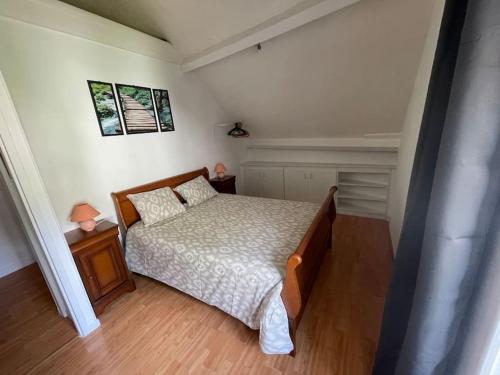 a small bedroom with a bed and two night stands at Maison avec terrasse avec vue sur la Reculée in Les Planches-près-Arbois