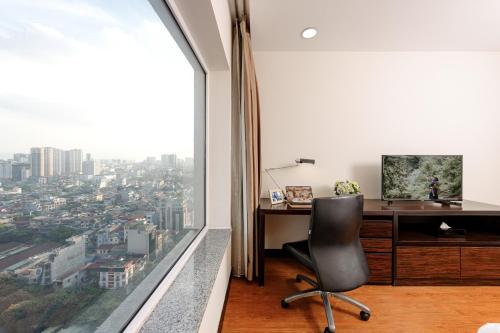 an office with a desk and a large window at Somerset Hoa Binh Hanoi in Hanoi