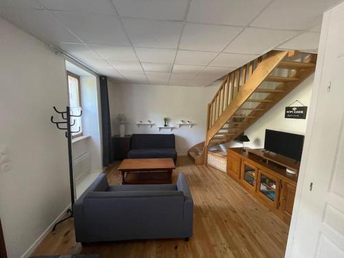 a living room with a couch and a table at Maison avec terrasse avec vue sur la Reculée in Les Planches-près-Arbois