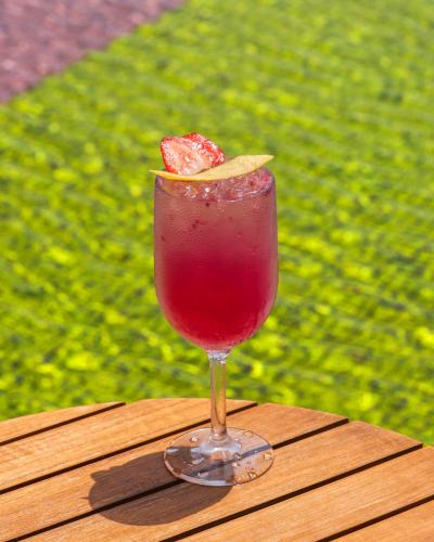 a drink in a glass sitting on a wooden table at SO/ Maldives in South Male Atoll