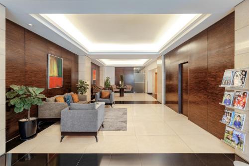 a lobby of a hotel with couches and chairs at Somerset Hoa Binh Hanoi in Hanoi