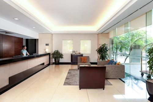a lobby of a hotel with a person standing in the lobby at Somerset Hoa Binh Hanoi in Hanoi