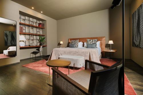 a bedroom with a bed and a table and chairs at Can Alomar Hotel in Palma de Mallorca