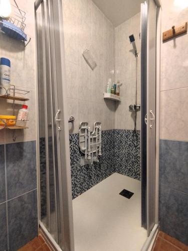 a shower with a glass door in a bathroom at Apartamento OsMa in Bolnuevo