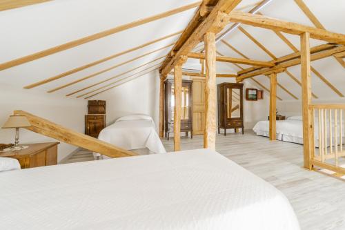 a bedroom with two beds in a room with wooden beams at Abánades in Melgar de Fernamental