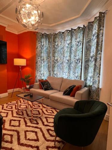 a living room with a couch and a rug at Stunning 5 bedroom home Wirral Birkenhead Sleeps 9- Free Parking-5G Internet in Birkenhead