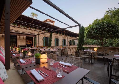 an outdoor dining area with tables and chairs at Can Alomar Hotel in Palma de Mallorca