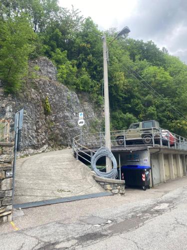 a car on a bridge with a truck on it at La Piudana Como Lake in Ponna Superiore
