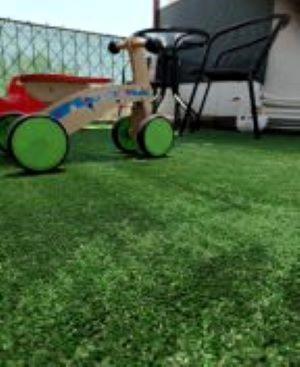 a skateboard with green wheels sitting in the grass at River House in Volos