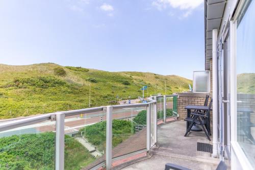 a balcony with a view of a hill at Beach appartement 40 in Callantsoog