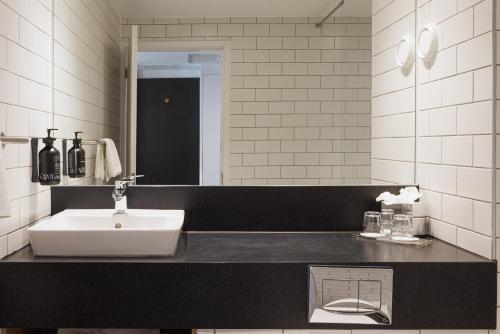 a bathroom with a sink and a mirror at Holiday Inn South Normanton M1, Jct.28 by IHG in South Normanton