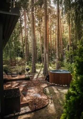 a backyard with a hot tub in the middle of a forest at Hot Tub SPA in the Woods in Yarvekyulya