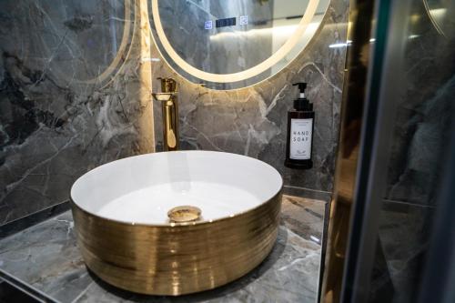 a tub in a bathroom with a mirror and a sink at La Villa Ora in Antibes