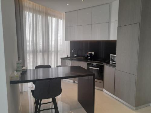 a kitchen with a table and two chairs in it at 360 Building - City View 2 Bedroom Residence in Nicosia