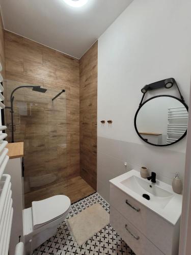 a bathroom with a toilet and a sink and a shower at Cicha 3 in Sztutowo