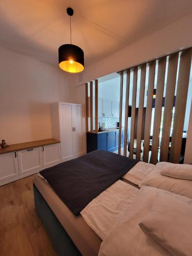 a bedroom with a large bed and a balcony at Cicha 3 in Sztutowo