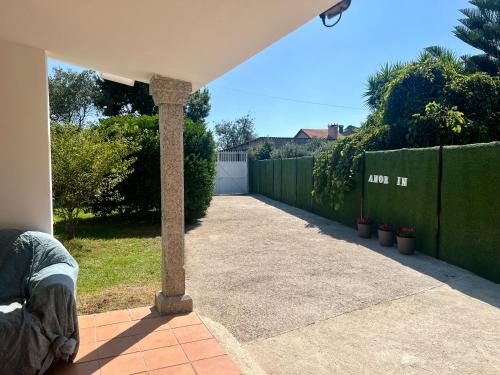 a stone pillar in a backyard with a fence at Amor-In in Amorín